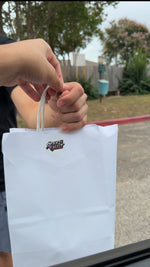 Customer receiving an OtakuVaultt shopping bag